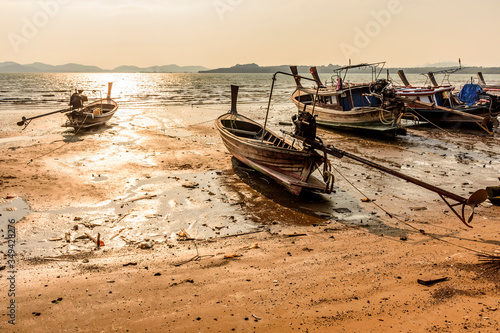Beached boats at low tide during golden hour on Ko Yao Noi island in Phang-Nga Bay near Phuket, Thailand