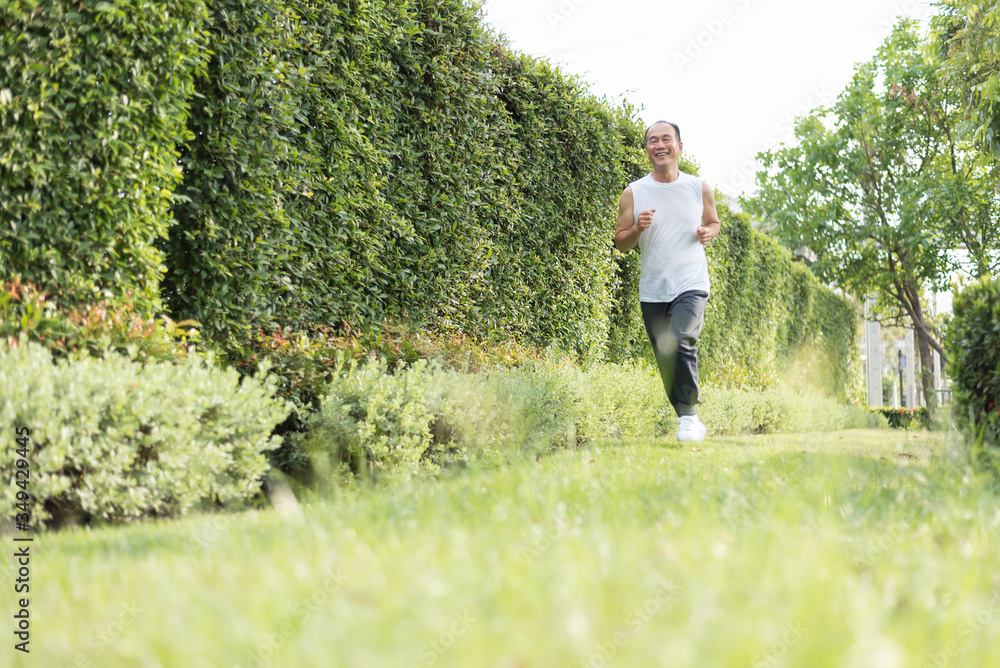 Happy Healthy Asian Senior man enjoying workout at outdoor. Smiling Elderly male jogging exercise for Wellness at the park. Happy Healthy Asian Senior man enjoying workout at outdoor. Smiling Elderly male jogging exercise for Wellness at the park.