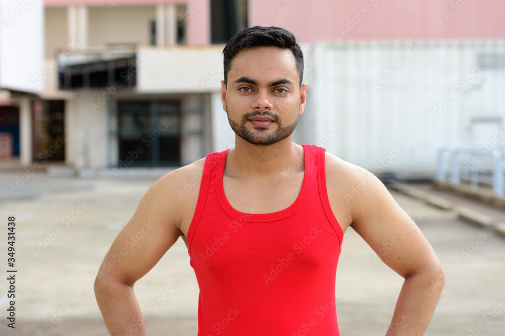 Young bearded Indian man ready for exercising outdoors Young bearded Indian man ready for exercising outdoors