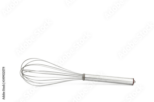 Close up egg beater over white background from side view.