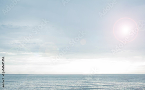 Landscape of peaceful gloomy blue sea and sky with light right ray. Space for user to put text and for background purpose.