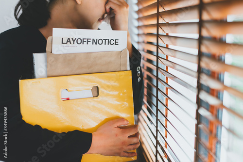 Female employee have stress and sadness after receiving a layoff notice. The impact of the economic recession during the Covid-19(corona virus) outbreak. photo