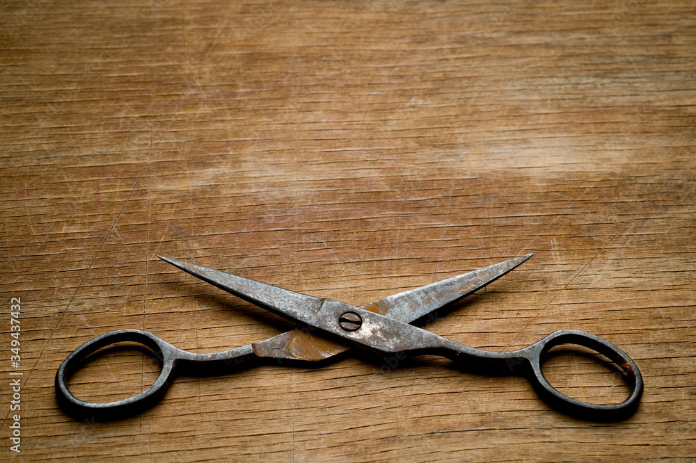 Old iron scissors of the last century covered with rust, removed from the chest in the workshop of grandfather. Background for craftsmanship and manual labor. Old iron scissors of the last century covered with rust, removed from the chest in the workshop of grandfather. Background for craftsmanship and manual labor.