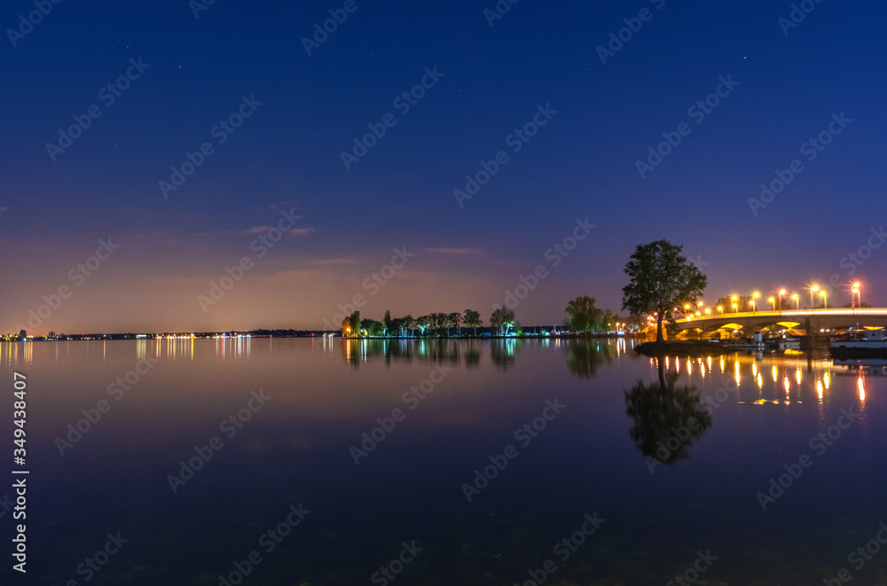 charming landscape on the river at sunset and night time