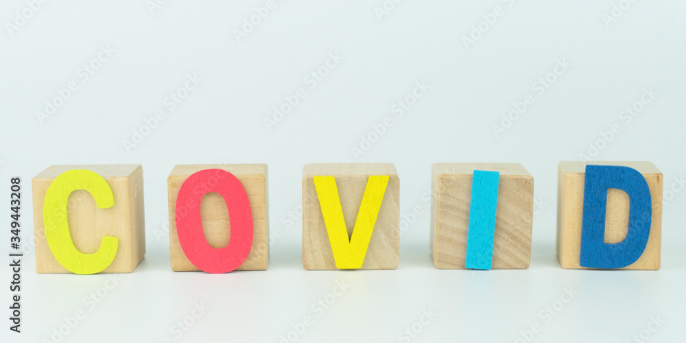Wooden blocks with alphabet of COVID.text message on white background Wooden blocks with alphabet of COVID.text message on white background
