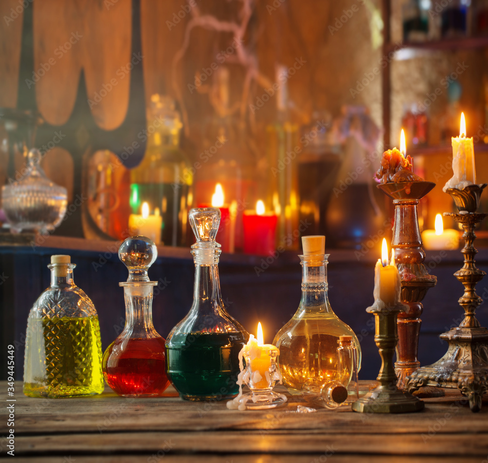 magic potions in bottles on wooden background magic potions in bottles on wooden background