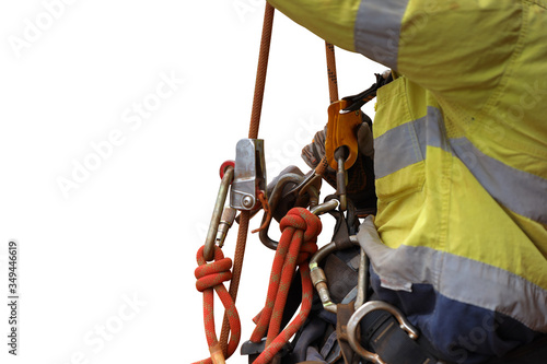 Rope access industry abseiler worker working at height abseiling resting by hanging on fall safety body chest harness safety secondary ascender device with isolated white background   