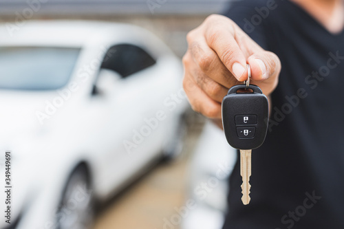 Businessman giving a car key. Getting new car.