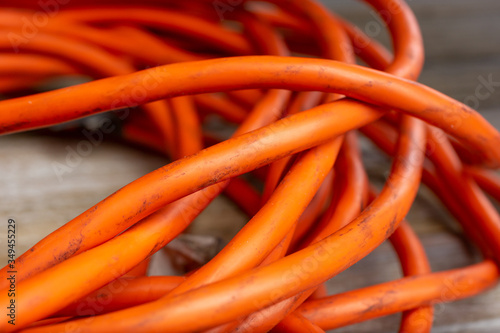 A closeup view of the wires that make up an orange extension cord. photo