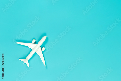 Model plane, airplane on blue pastel color background with copy space, Flat lay design travel concept on blue background. top view model plane on blue color background. © zoneteen
