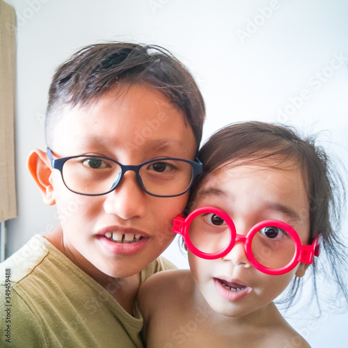 Wallpaper Mural Happy toddler girl playing with red fake sunglasses at home. Torontodigital.ca