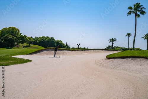 Golf Course with sand bunker. Golf course with a rich green turf beautiful scenery.