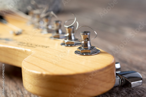A closeup view of the tuner pegs of an electric guitar.