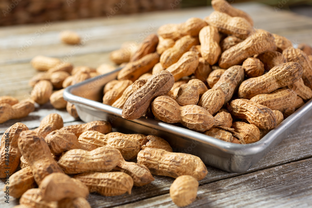 A view of a metal tray full of peanuts. A view of a metal tray full of peanuts.