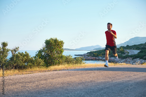 young man on a morning jog on the coastline road