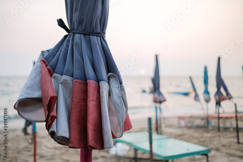 Close up umbrella isolated from beach and sea background with sunset.