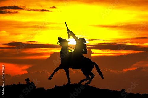 Cowboy Statue bei Sonnenuntergang photo