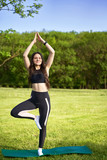 Yoga. Athletic girl doing stretching outdoors before she will practice yoga on the nature
