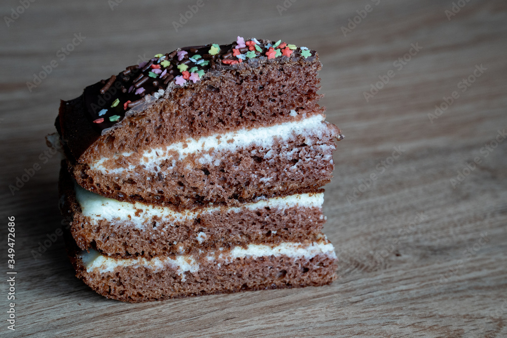 Chocolate Cake on the wooden background. One piece of sweet dessert with place for writing text