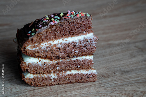 Obraz na płótnie Chocolate Cake on the wooden background. One piece of sweet dessert with place for writing text w salonie