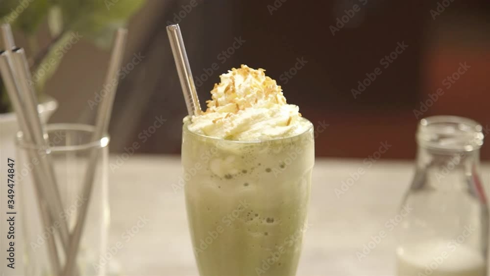 drink with whipped cream and a metal straw - slide right drink with whipped cream and a metal straw - slide right