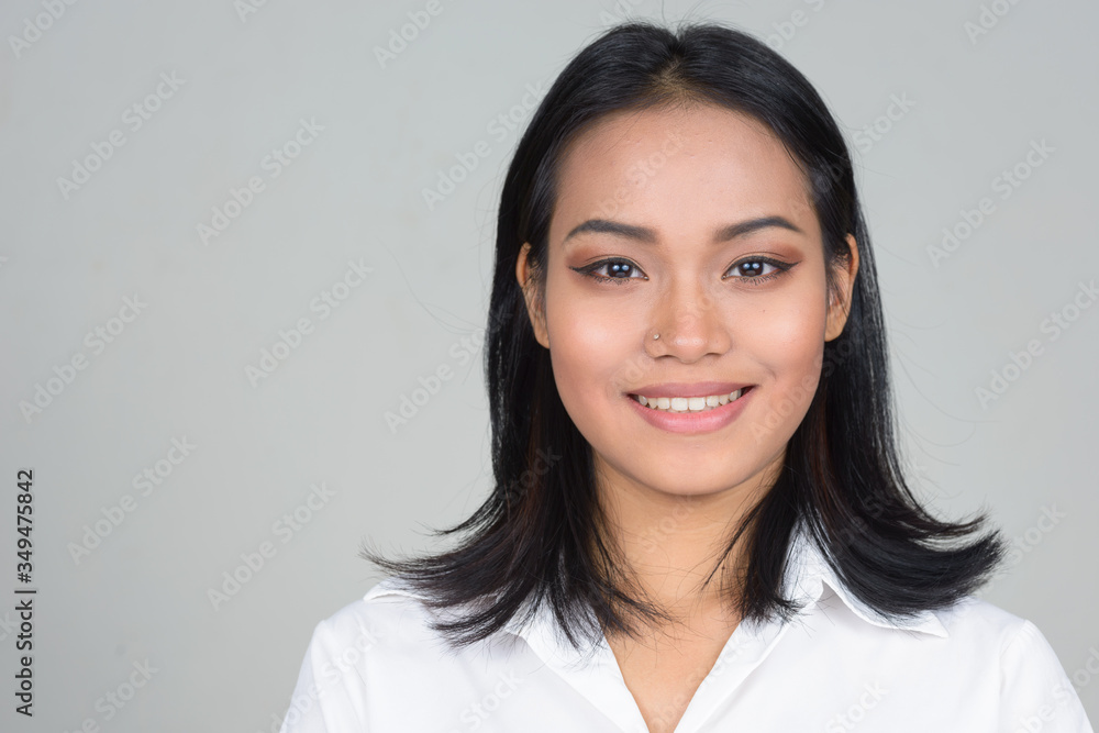Face of happy young beautiful Asian businesswoman smiling Face of happy young beautiful Asian businesswoman smiling