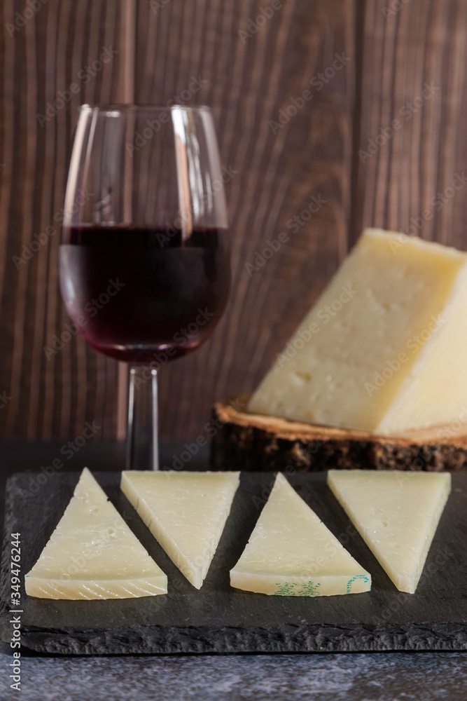 typical spanish manchego cheese and red wine glass typical spanish manchego cheese and red wine glass