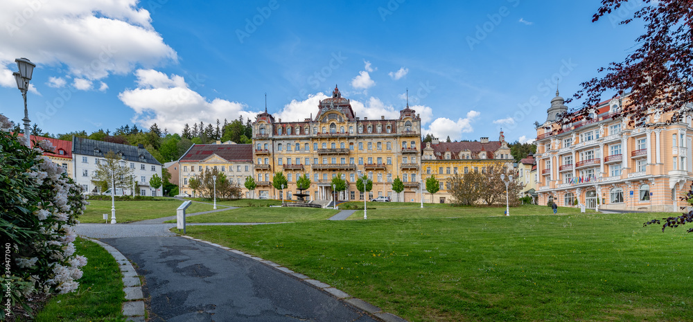 Fototapeta premium Goethe Square in small Czech spa town Marianske Lazne (Marienbad) - from the left museum, ruin of spa house Kavkaz and spa hotel