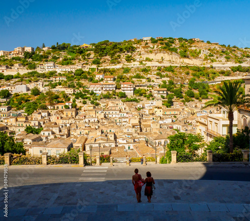Modica, Sicily, from the stairs of the cathedral of San Giorgio people look at the panorama in wonder (11/08/2019)