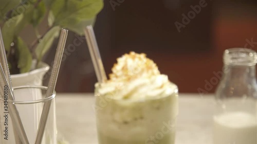 Whipped cream on the drink with straw - doly forward photo