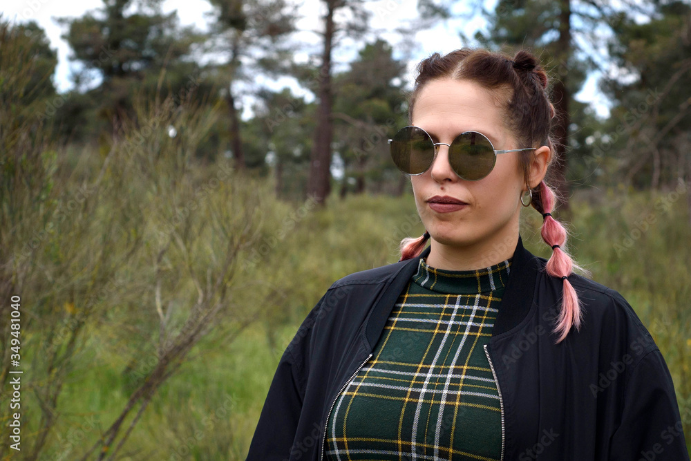 Woman with sunglasses in the field in spring, with her hair up Woman with sunglasses in the field in spring, with her hair up