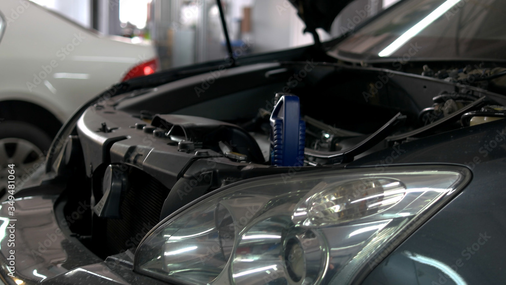Opened car engine. Close up headlights. Cars in a car service. Opened car engine. Close up headlights. Cars in a car service.