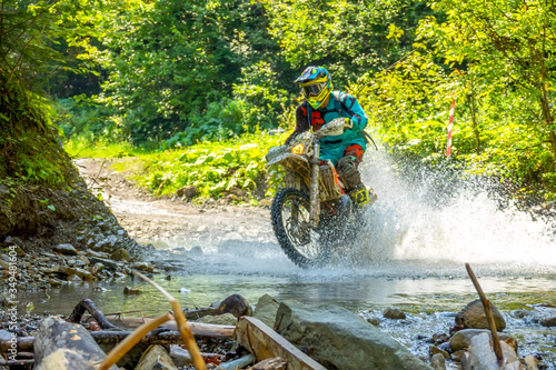 Enduro Racing in the Summer Sunny Forest and Spray