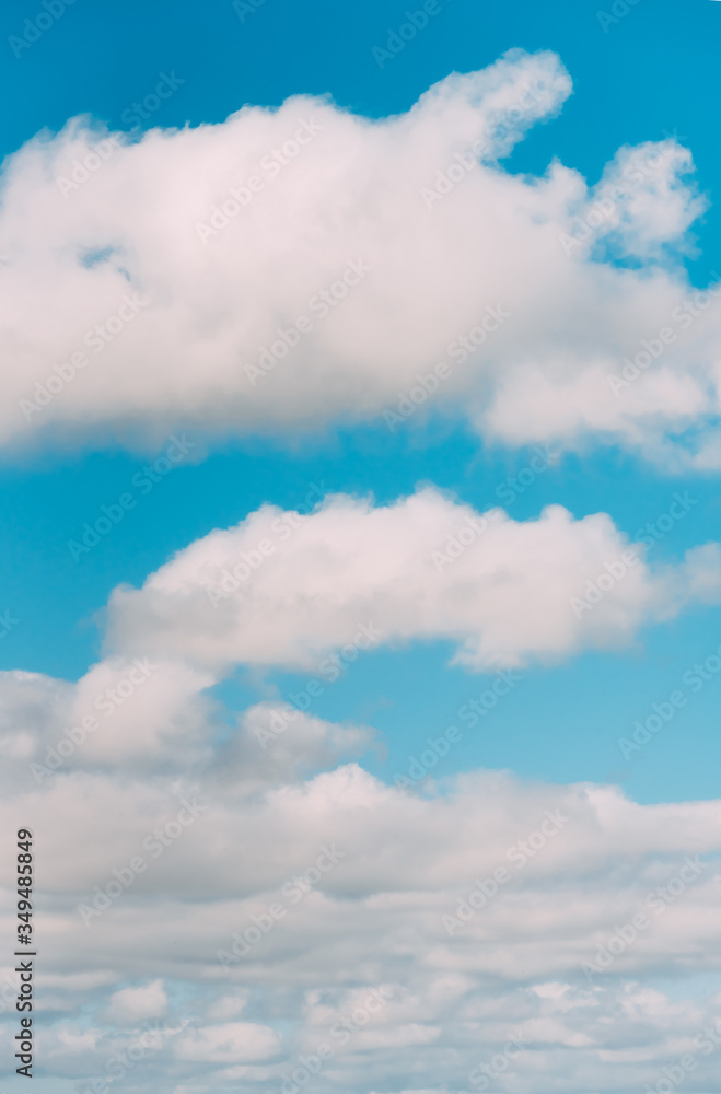 white clouds in a blue sky. Bright day, vertical photography white clouds in a blue sky. Bright day, vertical photography