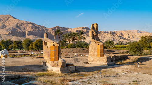 The Colossi of Memnon, two stone massive statues of the Pharaoh Amenhotep III, who reigned in Egypt during the Dynasty XVIII.