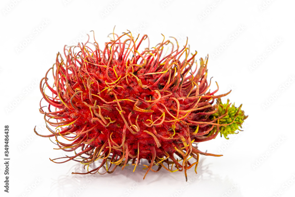 The fresh rambutan isolate with green leaf. Fresh Rambutan in bamboo basket on white background The fresh rambutan isolate with green leaf. Fresh Rambutan in bamboo basket on white background