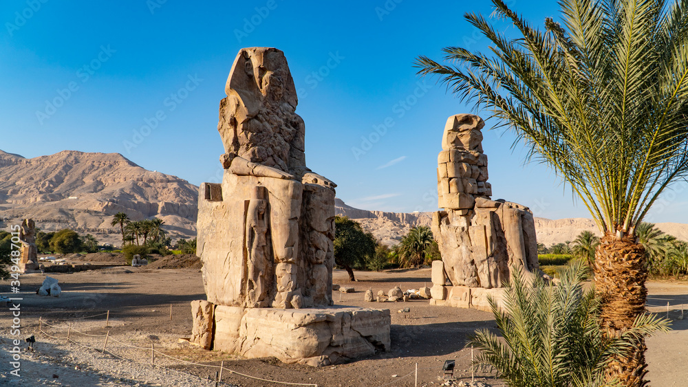 The Colossi of Memnon, two stone massive statues of the Pharaoh Amenhotep III, who reigned in Egypt during the Dynasty XVIII.