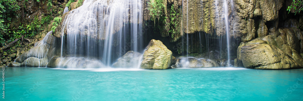 Fototapeta premium Beauty in nature, beautiful waterfall flowing of water with turquoise color of water in fresh rain forest or jungle of tropical climate. 
