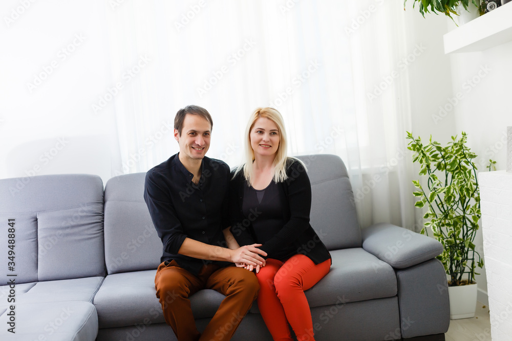 Happy young couple is hugging and smiling while sitting on the couch at the psychotherapist. Happy young couple is hugging and smiling while sitting on the couch at the psychotherapist.