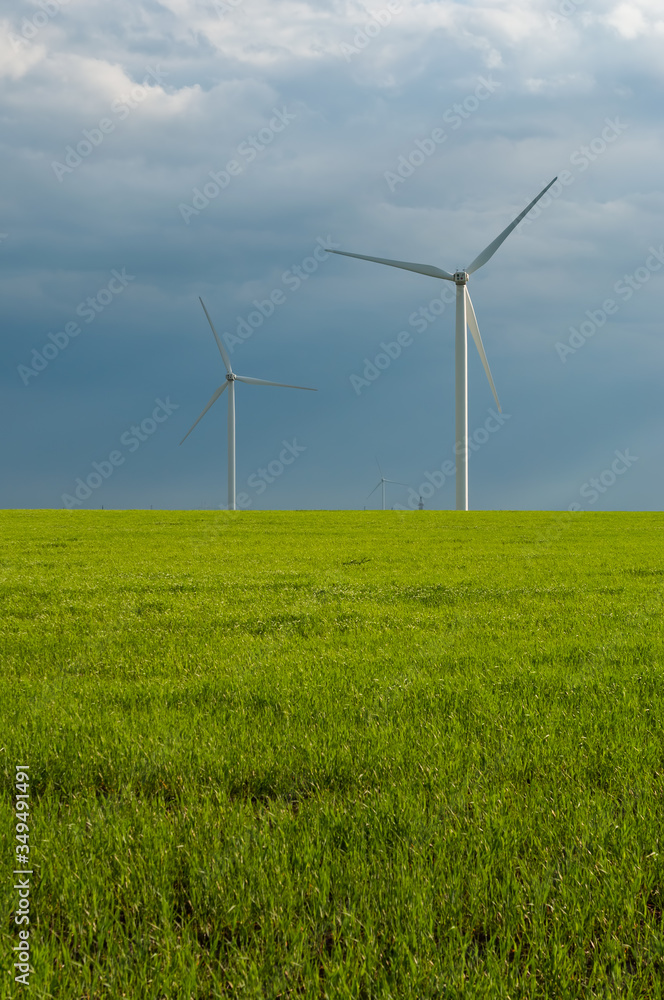 Landscape view of wind power turbine among green meadow with sky in the morning and copy space for text in the sky. Green energy concept. Landscape view of wind power turbine among green meadow with sky in the morning and copy space for text in the sky. Green energy concept.