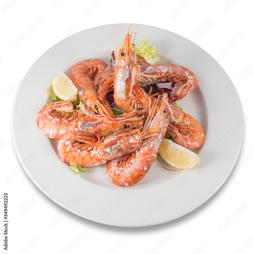 Plate of grilled jumbo shrimp with lemon and endive. Plate of grilled jumbo shrimp with lemon and endive.