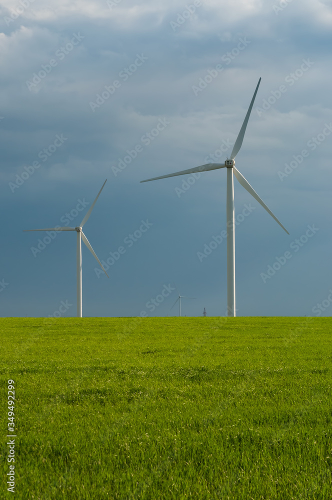Landscape view of wind power turbine among green meadow with sky in the morning and copy space for text in the sky. Green energy concept. Landscape view of wind power turbine among green meadow with sky in the morning and copy space for text in the sky. Green energy concept.
