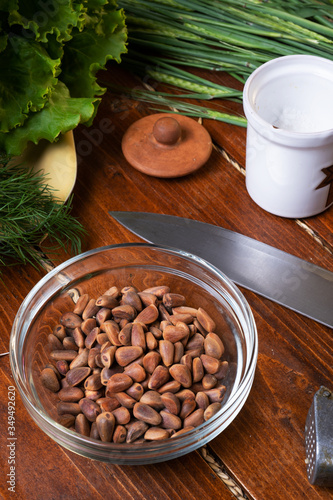 ingredients for pesto sauce with pine nuts  laying at wooden table photo