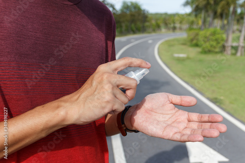 The man use alcohol to clean hands for prevention of coronavirus virus outbreak. COIVD 19 photo