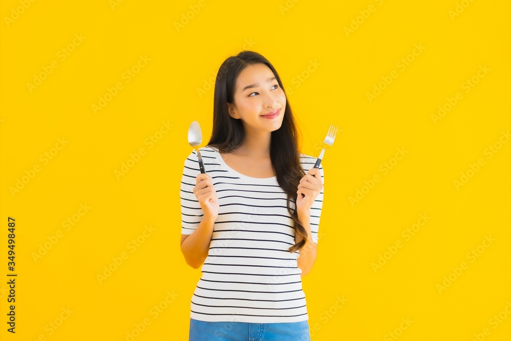 Portrait beautiful young asian woman show spoon and fork ready to eat Portrait beautiful young asian woman show spoon and fork ready to eat