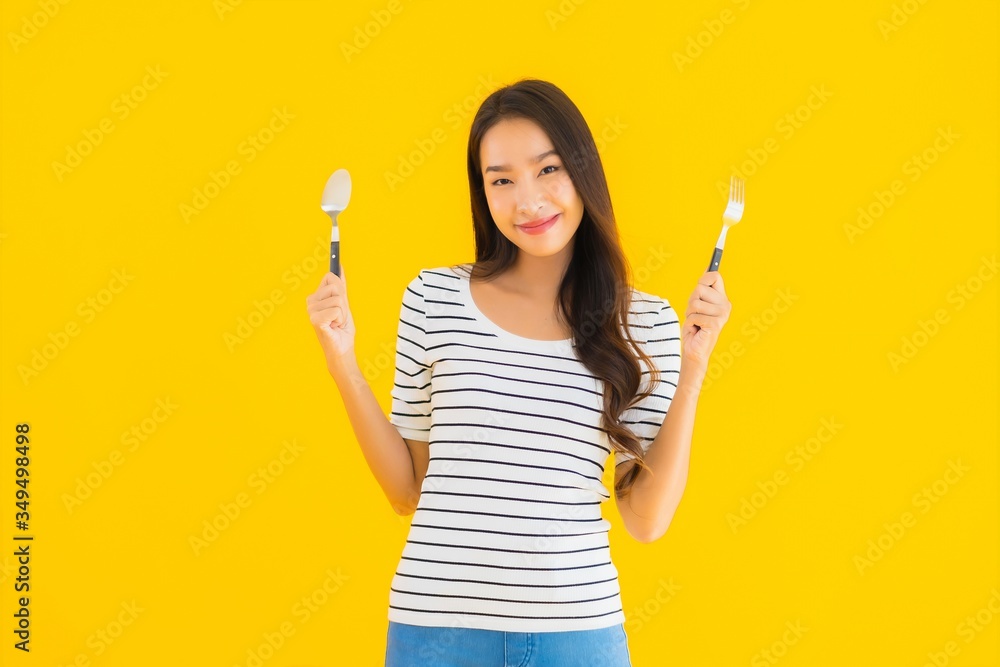 Portrait beautiful young asian woman show spoon and fork ready to eat Portrait beautiful young asian woman show spoon and fork ready to eat