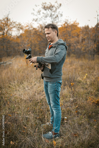 Positive camera man preparing camera on digital stabilizer for shooting photo and video content © Svyatoslav Lypynskyy
