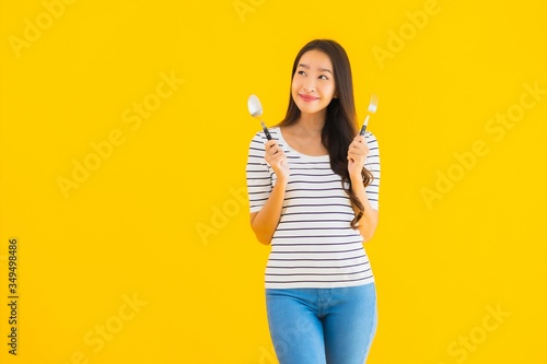 Portrait beautiful young asian woman show spoon and fork ready to eat © siraphol