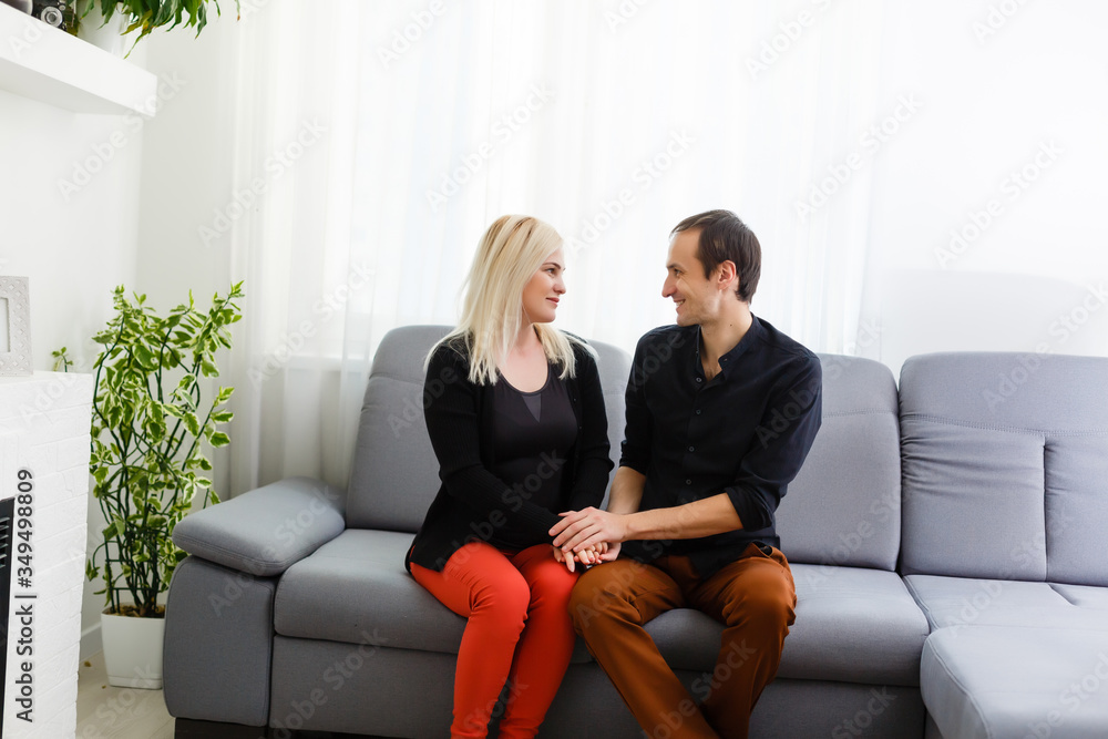 Happy young couple is hugging and smiling while sitting on the couch at the psychotherapist. Happy young couple is hugging and smiling while sitting on the couch at the psychotherapist.