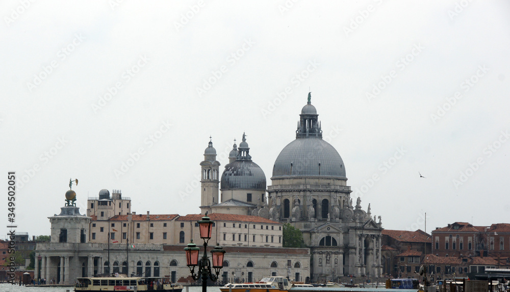 Cityscape with Santa Maria della Salute church, historical facades in Venice. View from the adriatic sea.